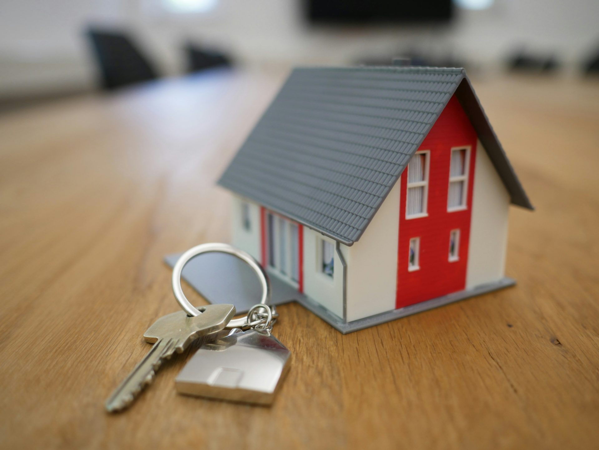 Casa de madera en miniatura blanca y roja sobre mesa marrón